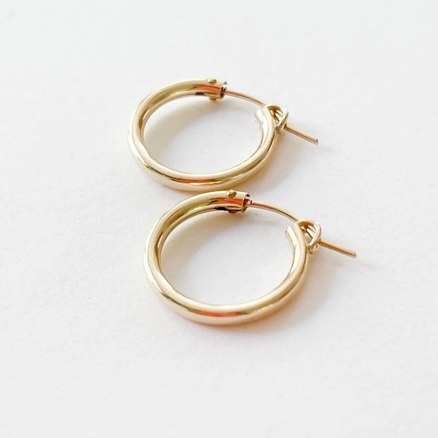 Thick gold hoops and Huggies
